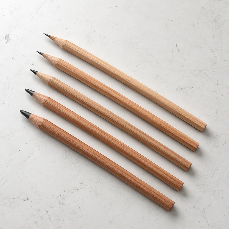 Graphite pencils on a lightly marked white studio table