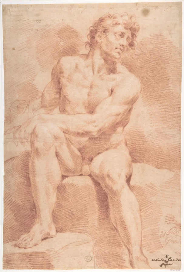 A seated male figure with crossed arms and bent knees.