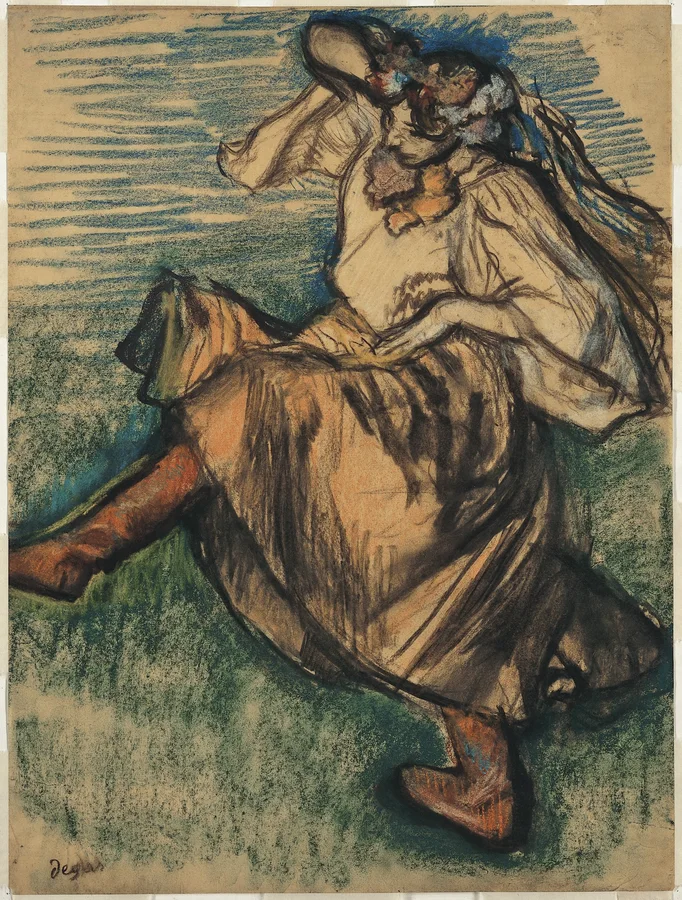 A dancer in Ukrainian dress with a lifted leg and raised arms.
